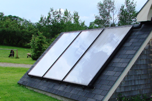 3 solar panels on a low shed roof