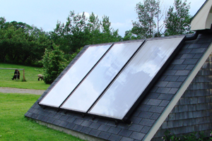 3 solar panels on a low shed roof