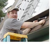 worker installing solar panels