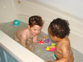 Happy kids bathing in domestic hot water heated by radiant solar.